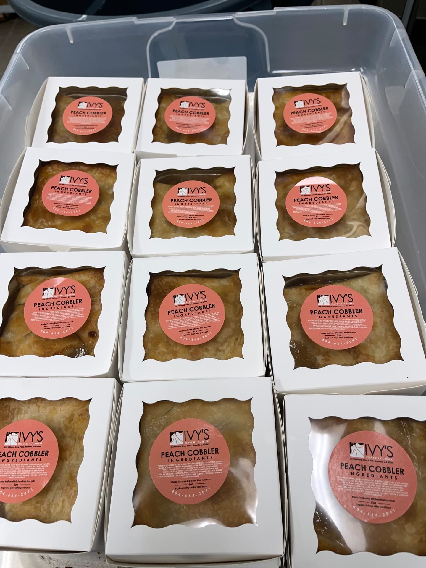 Boxed 5 oz peach cobblers with Ivy's labels packed for pickup
